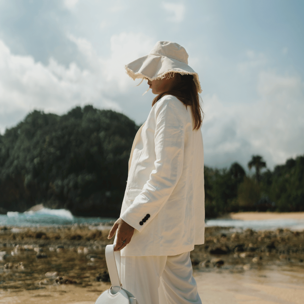 women in white outfit with summer bucket hat